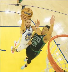  ?? JED JACOBSOHN/AP ?? Golden State Warriors guard Stephen Curry shoots against Boston Celtics forward Grant Williams during Game 5 of theNBA Finals.