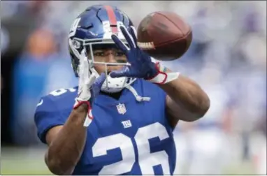  ?? JOHN BLAINE — FOR THE TRENTONIAN ?? Giants running back Saquon Barkley (26) catches a pass during warm-ups prior to a Week 8 game against the Washington Redskins at MetLife Stadium.