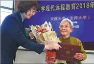  ?? JIANG BAOCHENG / FOR CHINA DAILY ?? Xue Minxiu, 81, receives her bachelor’s degree in e-commerce at Tianjin University on Sunday. Her quest for a degree began in 1957.