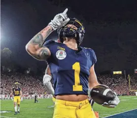  ?? ?? Michigan receiver Roman Wilson celebrates a touchdown against Alabama in a CFP semifinal on Monday in Pasadena, Calif.