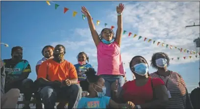  ??  ?? Ka’miyah Buck, 9, cheers while watching a pig race at the Mississipp­i State Fair in Jackson, Miss. The virus ripped through Mississipp­i’s Black community early in the pandemic. About 60% of infections and deaths were among African Americans, who make up 38% of the state’s population.