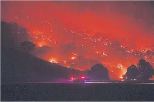  ?? SAM MOOY GETTY IMAGES ?? Firefighte­rs conduct property protection patrols at the Dunns Road fire on Friday. As of midday, they were battling 147 fires in New South Wales alone, with one at the highest emergency level.