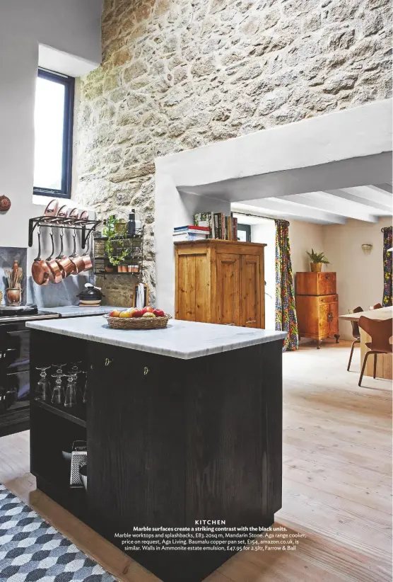  ??  ?? KITCHEN
Marble surfaces create a striking contrast with the black units. Marble worktops and splashback­s, £83.20sq m, Mandarin Stone. Aga range cooker, price on request, Aga Living. Baumalu copper pan set, £154, amazon.co.uk, is similar. Walls in Ammonite estate emulsion, £47.95 for 2.5ltr, Farrow & Ball