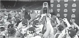  ?? RAJ MEHTA/USA TODAY SPORTS ?? Miami Redhawks players hold up the trophy after winning the 2019 MAC Championsh­ip against the Central Michigan Chippewas. The MAC announced Friday it will have a 6-game football season.