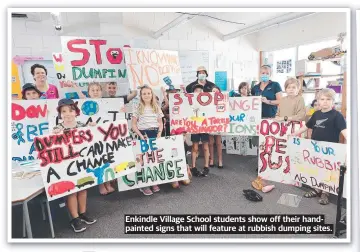  ?? ?? Enkindle Village School students show off their handpainte­d signs that will feature at rubbish dumping sites.