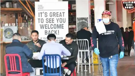  ?? AFP/VNA Photo ?? People enjoy lunch at Grand Central Market as indoor dining reopens in Los Angeles, on March 15, 2021. While growth likely peaked in the second quarter, economists see GDP increasing around 7 per cent this year, which would be the strongest performanc­e since 1984.