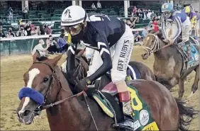  ?? Jeff Roberson / AP ?? Jockey John Velazquez looks to take Authentic to the winner’s circle at Pimlico on Saturday, as he did in winning the Kentucky Derby on Sept. 5.