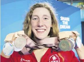  ?? RYAN REMIORZ/THE CANADIAN PRESS ?? Taylor Ruck, a native of Kelowna, B.C., holds her eight swimming medals at the Commonweal­th Games last week in Gold Coast, Australia. The 17-yearold swimmer was one of Canada’s bright spots at the games, winning one of the country’s 15 gold medals —...