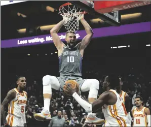  ?? PAUL KITAGAKI JR./SACRAMENTO BEE ?? Kings forward Domantas Sabonis (10) reacts after dunking the ball over Hawks forward Onyeka Okongwu (17) in Sacramento on Jan. 4.