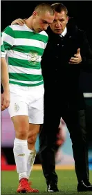  ??  ?? MAKING PLANS: Brown listens intently to Celtic manager Rodgers