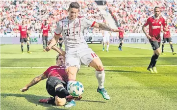  ??  ?? Bayern Munich’s Colombian midfielder James Rodriguez (right) and Hanover’s German defender Oliver Sorg vie for the ball during the German first division Bundesliga football match between Hannover 96 vs Bayern Munich in Hanover. — AFP photo