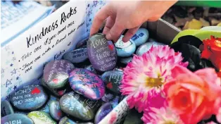  ?? PHOTO: REUTERS ?? Kindness rocks . . . Pebbles with messages at a memorial site for victims of Friday’s shooting in Christchur­ch.