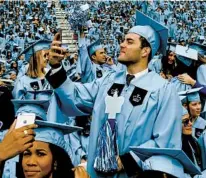  ?? TIMOTHY A. CLARY AFP VIA GETTY IMAGES ?? By 2021, discipline­s such as history, English and religion graduated less than half as many students as they did in their early 2000s, relative to the overall size of the graduating student body.