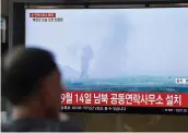  ?? — AFP ?? People watch a television news screen showing an explosion of an inter-Korean liaison office in North Korea’s Kaesong Industrial Complex at a railway station in Seoul on Tuesday.