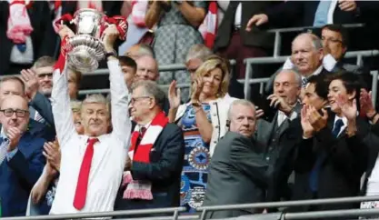  ?? — AFP ?? LONDON: This file photo taken on May 27, 2017 shows Arsenal’s French manager Arsene Wenger lifts the FA Cup trophy after their win over Chelsea in the English FA Cup final football match between Arsenal and Chelsea at Wembley stadium in London on May...
