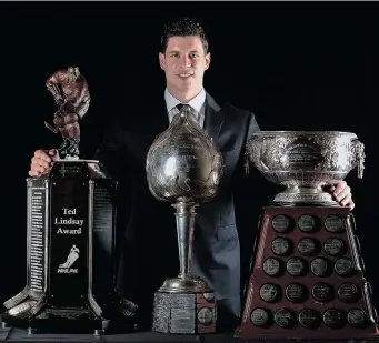  ?? HARRY HOW/ GETTY IMAGES ?? Sidney Crosby of the Pittsburgh Penguins is shown with the Ted Lindsay Award, the Hart Memorial Trophy and the Art Ross Trophy during the 2014 NHL Awards handed out in Las Vegas on Tuesday.