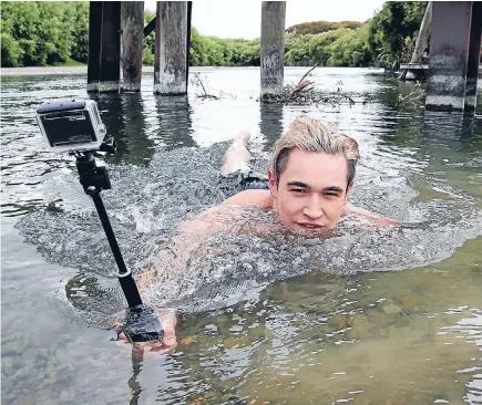  ?? PHOTO: ROBYN EDIE/FAIRFAX NZ 631863256 ?? Jordan Hopa, 21, of Invercargi­ll, films part of his short film in the Oreti River, at Branxholme on Thursday.