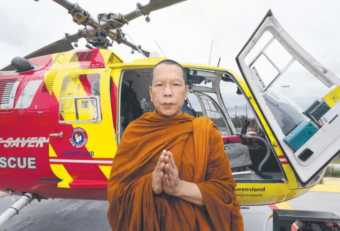  ?? Picture: RICHARD GOSLING ?? Thai monk Luang Por Pumee blesses the Surf Life Saving Queensland Westpac helicopter.