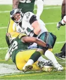  ?? BENNY SIEU/USA TODAY SPORTS ?? Eagles quarterbac­k Carson Wentz is sacked by Packers outside linebacker Rashan Gary last Sunday at Lambeau Field.