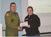  ??  ?? Shannon LaBuick accepts a volunteer certificat­e from O’Reilly.