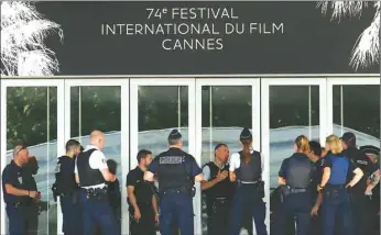  ?? (Reuters) ?? French police stand in front of the main entrance of the Festival Palace on the eve of the opening ceremony of 74th Cannes Film Festival.