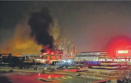  ?? AP ?? A massive blaze is seen over the Crocus City Hall on the western edge of Moscow, Russia, on Friday.