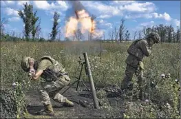  ?? Libkos ?? UKRAINIAN troops fire a mortar round toward Russian positions near the eastern city of Bakhmut. Ukraine reported some success near a key southern village.