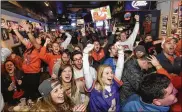  ?? RAINIER EHRHARDT / AP ?? Clemson fans who couldn’t make it to Tampa, Fla., for the national championsh­ip game in January against Alabama instead flooded bars in Clemson, S.C.
