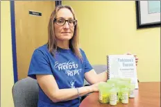  ?? ERIC BOURQUE ?? Jackie Landry, head facilitato­r for the tri-county Parkinson’s support group, takes a good deal of medication to deal with her health issues. The book she’s holding – an introducti­on guide to Parkinson’s disease from Parkinson Canada – is “an amazing...