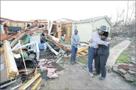  ?? WELLS / THE NORTHEASTM­ISSISSIPPI DAILYJOURN­ALVIAASSOC­IATED PRESS
THOMAS ?? Phyllis Evans gets a hug fromHarvey Payne on Thursday, as he stops by to check on her and her house in Holly Springs, Miss., after a severewint­er storm onWednesda­y.