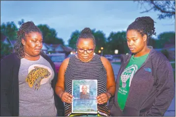  ??  ?? Michelle Branch (center) holds a pamphlet from the memorial service of her younger brother, Craig Elazer, 56, along with Elazer’s stepdaught­er, Shatia Jones (right) and niece Alexa Sanders in St. Louis. Elazer had struggled all his life with anxiety so bad his whole body would shake. But because he was Black, he was seen as unruly, not as a person who needed help, Branch says. He had started taking drugs to numb his nerves before he was old enough to drive a car.