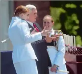  ?? PHOTOS BY TIM MARTIN THE DAY ?? Right, Ensign Jacklyn Kokomoor, left, and Vice President Michael Pence strike a pose.