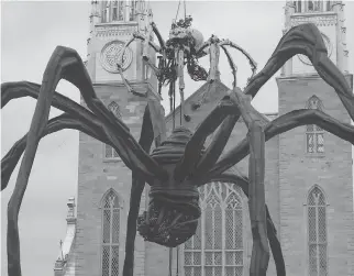  ?? JEAN LEVAC ?? Kumo, the spider from La Machine, perches atop Notre Dame Cathedral but appears to be facing off with Maman, the permanent spider sculpture outside the National Gallery.