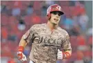  ?? JOHN MINCHILLO/THE ASSOCIATED PRESS ?? The Reds’ Scooter Gennett runs the bases after hitting a two-run home run during Tuesday’s game against the Cardinals in Cincinnati.