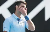  ?? DAVID GRAY/AFP ?? Novak Djokovic looks on while playing against Jannik Sinner during their Australian Open semifinal match on Friday in Melbourne.