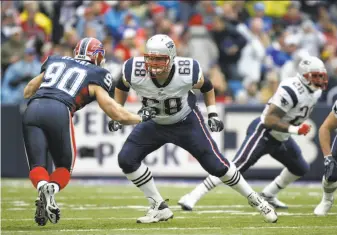  ?? George Gojkovich / Getty Images 2006 ?? Offensive lineman Ryan O’Callaghan (center) provides pass protection during a 2006 game while playing for New England. He started seven games for the Patriots in 2006 and ’07.