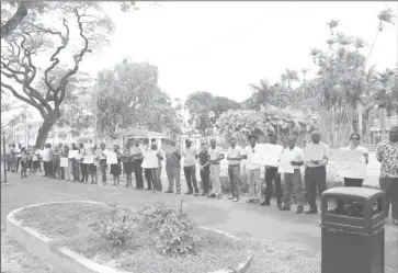  ??  ?? Dozens of junior and senior GPL managers used their lunch break yesterday to stage a protest outside of their Main Street office in Georgetown.