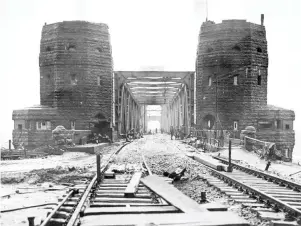  ?? — AFP photo ?? File photo shows the railway bridge over the Rhine at Remagen after it was captured intact by the 9th US Armoured Division, 1rst Army by the end of World War II. (Right) The two towers of the destroyed bridge pictured on Monday.