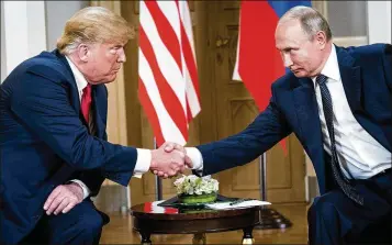  ?? DOUG MILLS / THE NEW YORK TIMES ?? President Donald Trump shakes hands with Russian President Vladimir Putin during their meeting in Helsinki on Monday. Trump wants to hold another meeting with Putin in the fall.