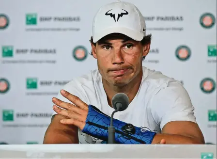  ??  ?? dealt with a bad hand: Spaniard Rafael Nadal announcing his withdrawal from the French Open during a press conference on Friday. — AP