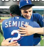  ?? Getty Images; USA Today Sports ?? JOB’S DONE: World Series MVP Corey Seager hugs Marcus Semien after the Rangers, aided by Mitch Garver’s goahead single in the seventh (right) broke a scoreless tie, finished off Arizona in Game 5.