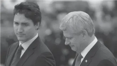  ?? SEAN KILPATRICK/THE CANADIAN PRESS ?? Justin Trudeau and Stephen Harper at a ceremony in Ottawa on Thursday, honouring two fallen Canadian soldiers.