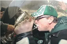  ?? JONATHAN HAYWARD/THE CANADIAN PRESS FILES ?? Premier Brad Wall drank from the Grey Cup at Taylor Field in 2013 after the Saskatchew­an Roughrider­s beat the Hamilton Tiger-Cats in the CFL’s title game.