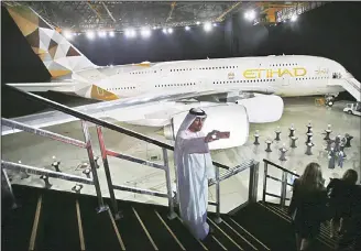  ??  ?? In this Dec 18, 2014 file photo, an Emirati man takes a selfie in front of a new Etihad Airways A380 in Abu Dhabi, United Arab Emirates. Etihad, the flag carrier of the United Arab Emirates, said on July 27, 2017 it lost $1.87 billion
in 2016. (AP)