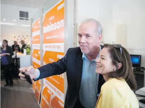  ?? DARRYL DYCK/THE CANADIAN PRESS ?? Housing minister Selina Robinson, with Premier John Horgan in May, says she plans to go over real estate transactio­n data to decide whether measures designed to improve housing affordabil­ity should be kept, revised or scrapped.