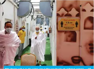  ?? — AFP ?? MINA: Pilgrims walk in an alley at their camp in Mina near the holy city of Makkah yesterday.