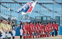  ??  ?? Japan (right) and Australia’s softball players listen to their national anthems at the Tokyo 2020 Olympic Games in Fukushima.