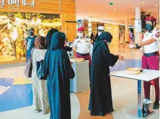  ?? Agencies ?? Guards record the temperatur­e of people entering a mall in Riyadh on Wednesday.