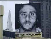  ?? ERIC RISBERG — THE ASSOCIATED PRESS ?? A large billboard stands on top of a Nike store showing former 49ers quarterbac­k Colin Kaepernick at Union Square, Wednesday in San Francisco.