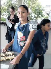  ??  ?? Tiana Gangaram with the gingerbrea­d men she made in the KZN Spar Junior Cook Competitio­n in Musgrave, Durban.